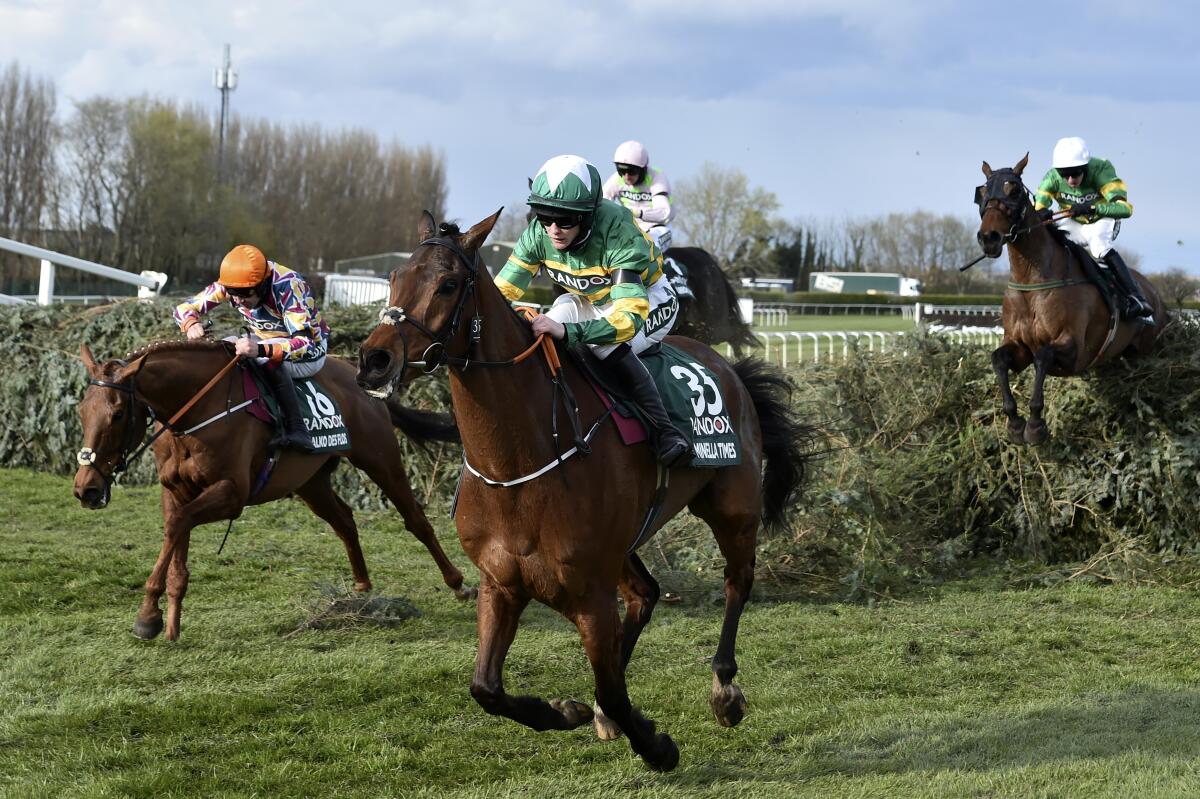 Rachael Blackmore ridding Minella Times clears the last fence to win the Randox Grand National Handicap Chase on the third day of the Grand National Horse Racing meeting at Aintree racecourse, near Liverpool, England, Saturday April 10, 2021. (Peter Powell/Pool via AP)