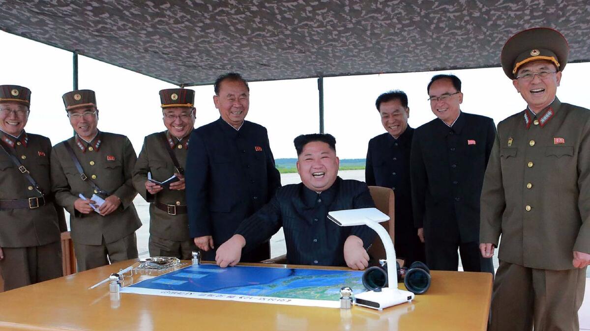 North Korean leader Kim Jong-Un watches the launch of an intermediate-range strategic ballistic rocket Hwasong-12 at an undisclosed location near Pyongyang.