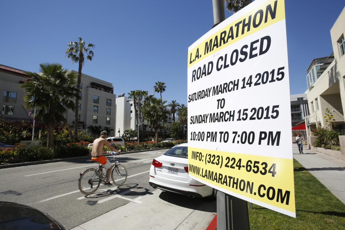 A sign posted on Ocean Avenue in Santa Monica warns travelers of road closures for the 30th annual Los Angeles Marathon on March 15.