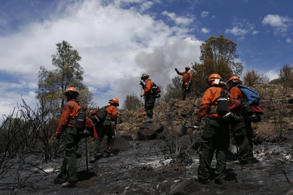 Inmate firefighters check for hotspots as they battle the Jerusalem fire near Lower Lake, Calif.