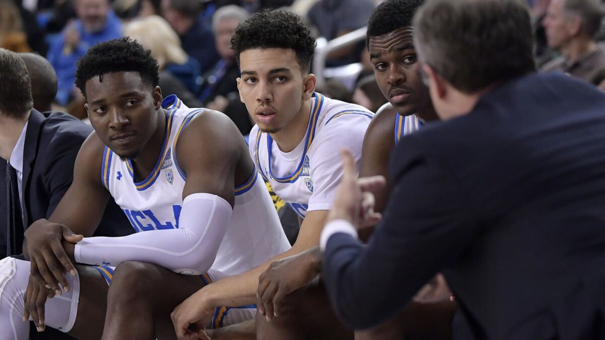 UCLA interim coach Murry Bartow, right, talks to his team during the second half against Stanford on Thursday. UCLA won 92-70.