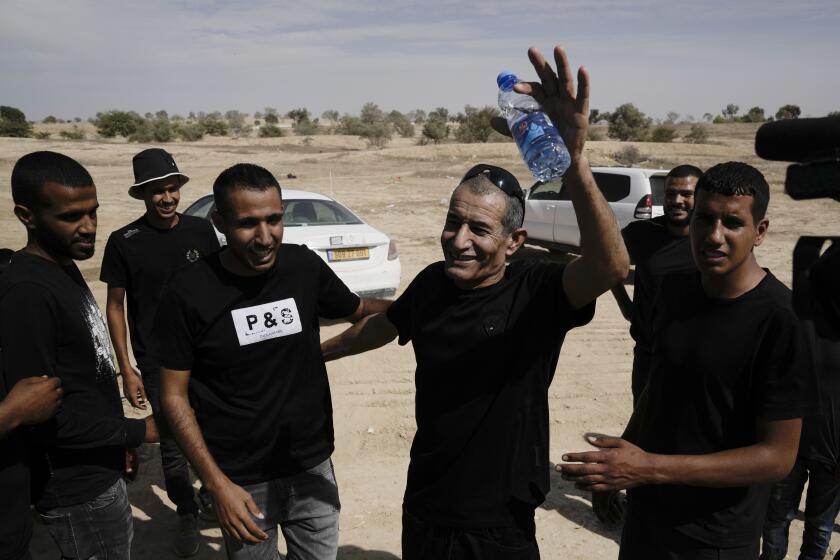 Qaid Farhan Alkadi, 52, who was held hostage by Hamas militants in Gaza Strip, meets his relatives and friends after arriving in the Khirbet Karkur village, near Rahat, southern Israel, Wednesday, Aug. 28, 2024. (AP Photo/Mahmoud Illean)