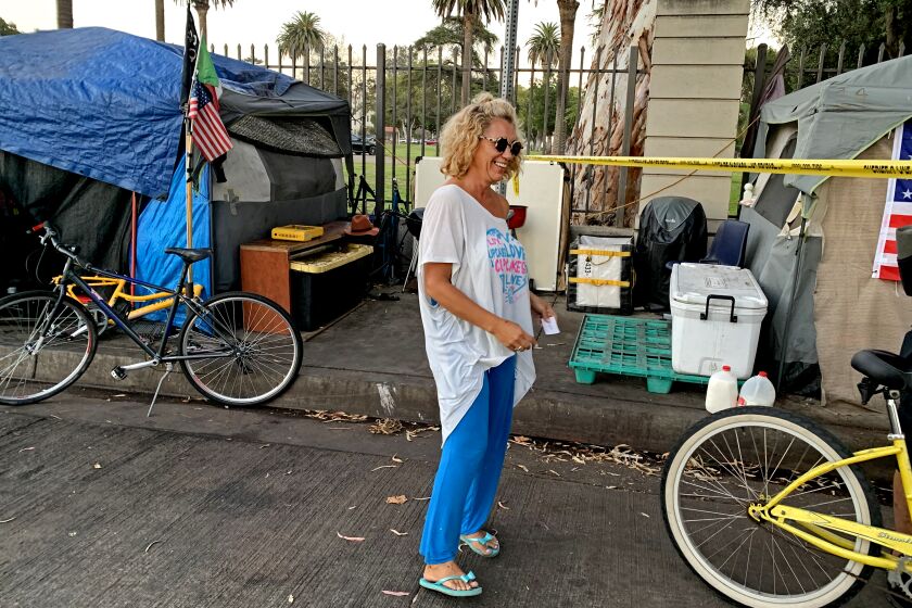 BRENTWOOD, CALIF. - SEPT. 15, 2021 - Shalise Garcia, also known as Coco, a resident of the encampment outside the grounds of the VA on San Vicente Blvd. in the Los Angeles neighborhood of Brentwood on Sept. 15, 2021, hours after a resident of the camp was fatally stabbed. (Carla Hall / Los Angeles Times)