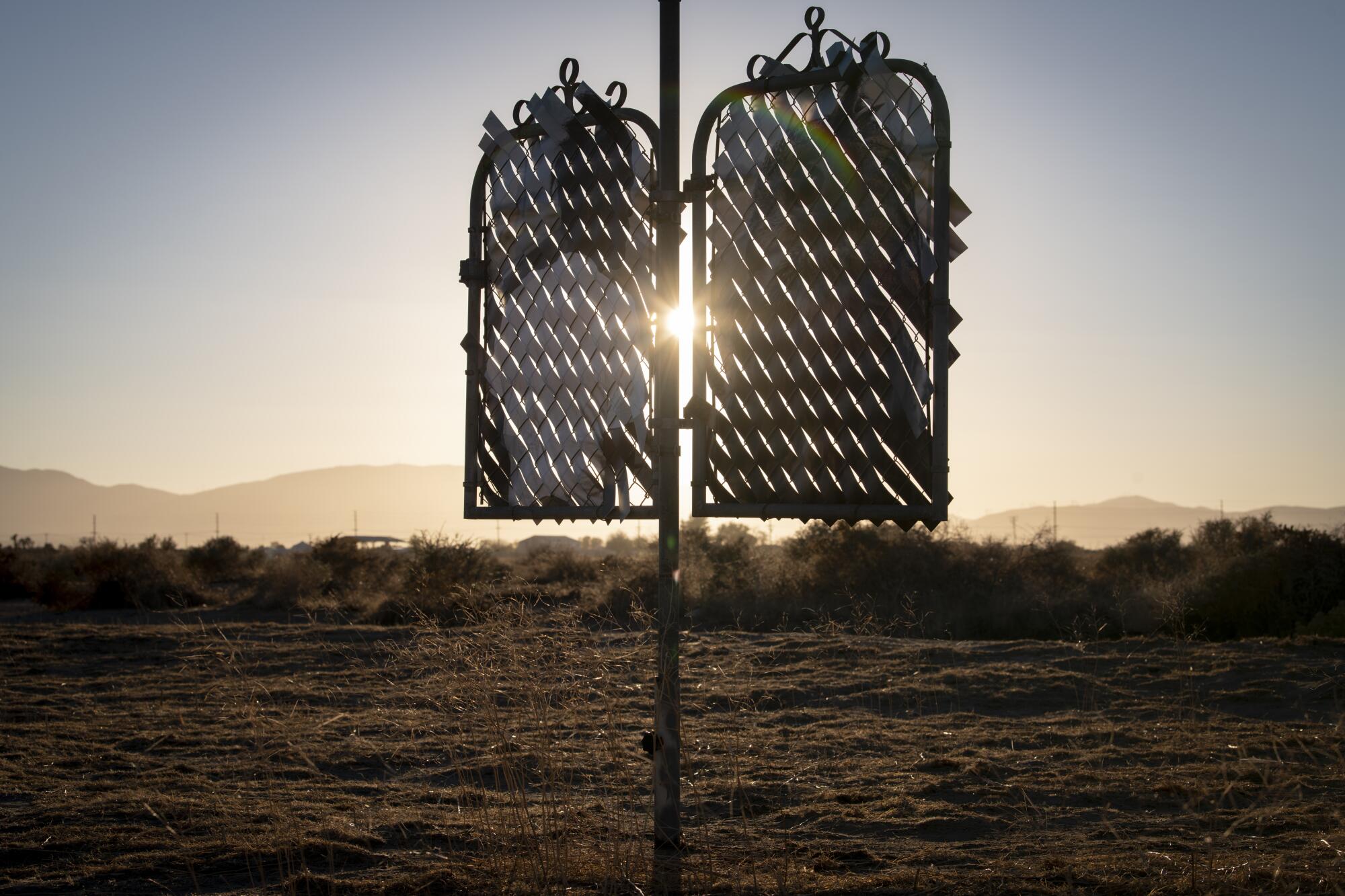 The sun sets behind "Desert Totem."