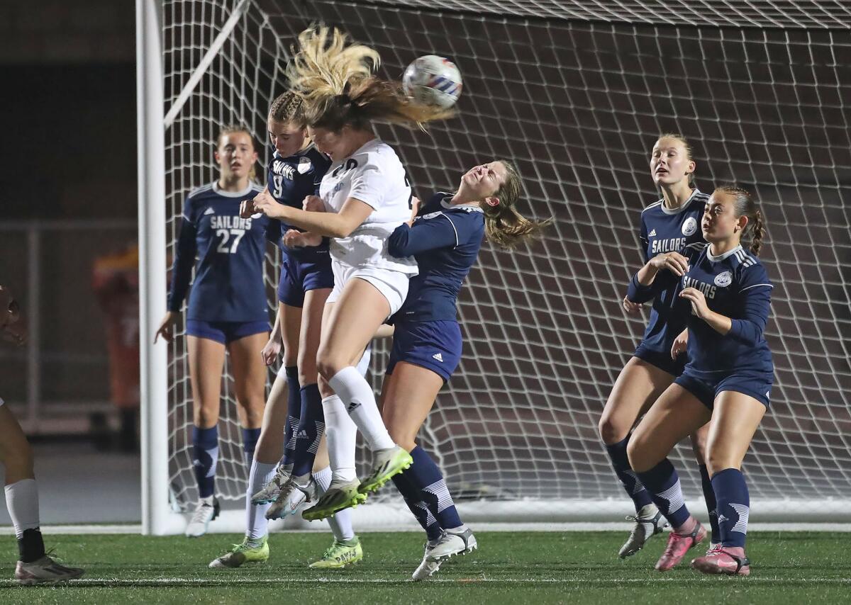 Corona del Mar's Lilly Borland (20) attempts to head the ball toward the goal.
