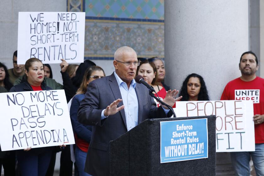 LOS ANGELES, CA - OCTOBER 15, 2019 Los Angeles City Councilman Mike Bonin, center, joined by tenants and community groups critical of Airbnb-type rentals, urged the city to not delay the enforcement of its regulations on renting out homes for short stays at a press conference on Tuesday, Oct. 15 at Los Angeles City Hall. (Al Seib / Los Angeles Times)