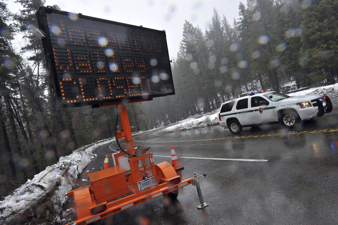 A sign at Wawona and Glacier Point roads alerts visitors that roads into Yosemite Valley in Yosemite National Park are closed.