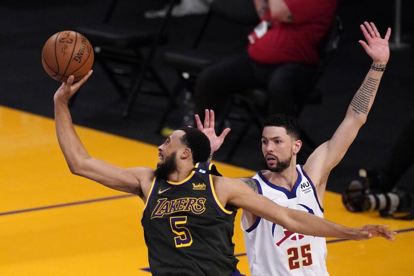 Los Angeles Lakers guard Talen Horton-Tucker, left, shoots as Denver Nuggets guard Austin Rivers defends during the second half of an NBA basketball game Monday, May 3, 2021, in Los Angeles. (AP Photo/Mark J. Terrill)