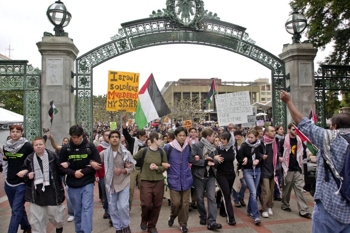 Pro–Palestinian demonstrators march through Sather Gate on the University of California, Berkeley campus, in April of 2002. Jewish students held a rally at the same time on campus to remember victims of the Holocaust.