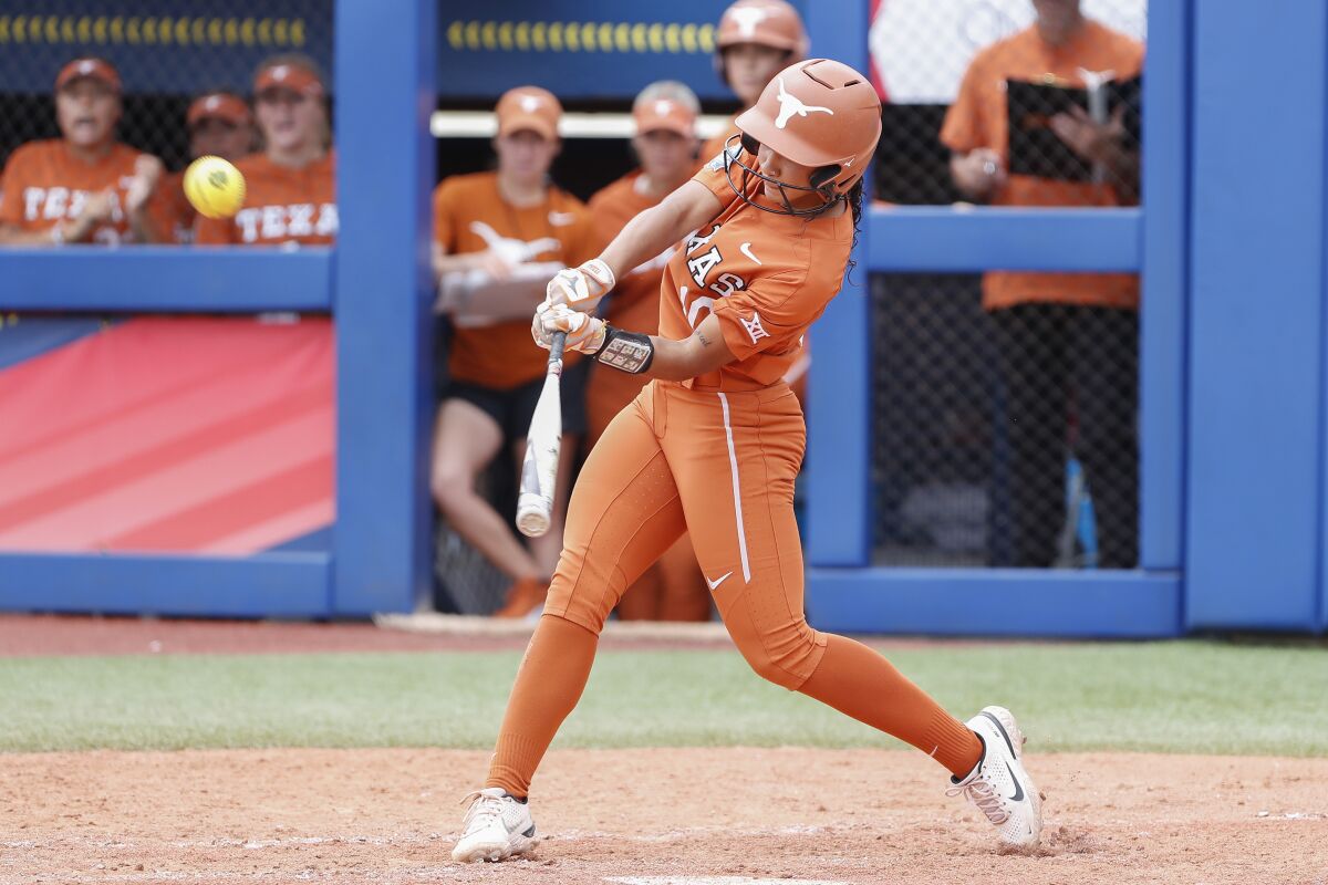 Texas' Mia Scott (10) hits against UCLA in the third inning of an NCAA softball Women's College World Series game on Thursday, June 2, 2022, in Oklahoma City. (AP Photo/Alonzo Adams)