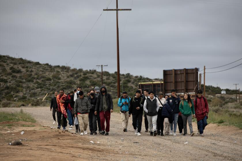 Jacumba Hot Springs, California - March 15: More than 60 migrants arrive to a camp just off of Interstate 8 waiting to be processed by U.S. Border Patrol on Friday, March 15, 2024 in outside of Jacumba Hot Springs, California. People came from Pakistan, Brazil, Dominican Republic, Bolivia, Honduras, Egypt, Somalia and other countries. (Ana Ramirez / The San Diego Union-Tribune)