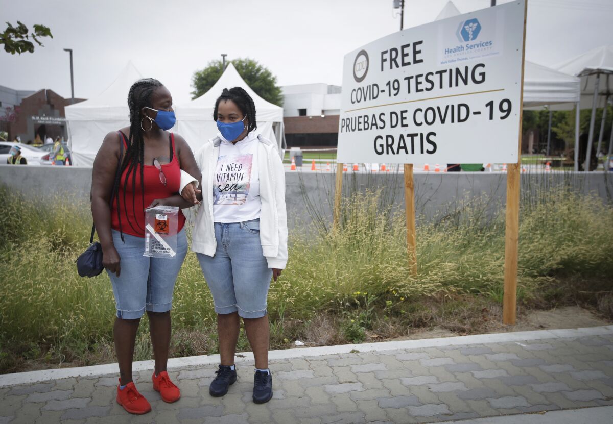 Valerie Jones accompanies her daughter, Keanna Navarre, to a COVID-19 test in Los Angeles.