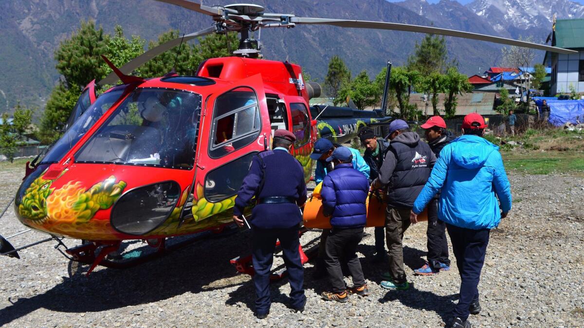 Officials carry the body of Min Bahadur Sherchan to a helicopter in Lukla, Nepal.