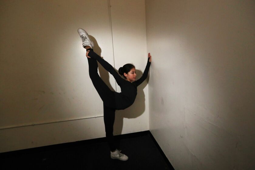 OAKLAND, CALIFORNIA - JANUARY 11: Alysa Liu, 13, of Richmond, stretches before she practices her technical program with her coach Laura Lipetsky at Oakland Ice Center in Oakland, Calif., on Friday, Jan. 11, 2019. Liu's technical program includes three triple axels and is heading to the U.S. figure skating championship in Detroit from Jan. 23 to 27. She is the youngest skater in the US history to complete in the 3 1/2-rotation jump. (Photo by Ray Chavez/Media News Group/The Mercury News via Getty Images)