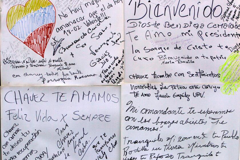Welcome home and get-well messages for Venezuelan President Hugo Chavez adorn a wall near Bolivar Square in Caracas, the capital, on Monday.