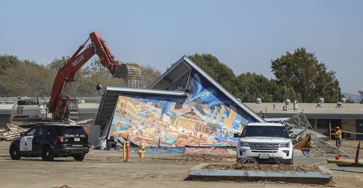 Despite protests, construction crews tear down a building with a art work by muralist Salvador Torres in Barrio Logan.