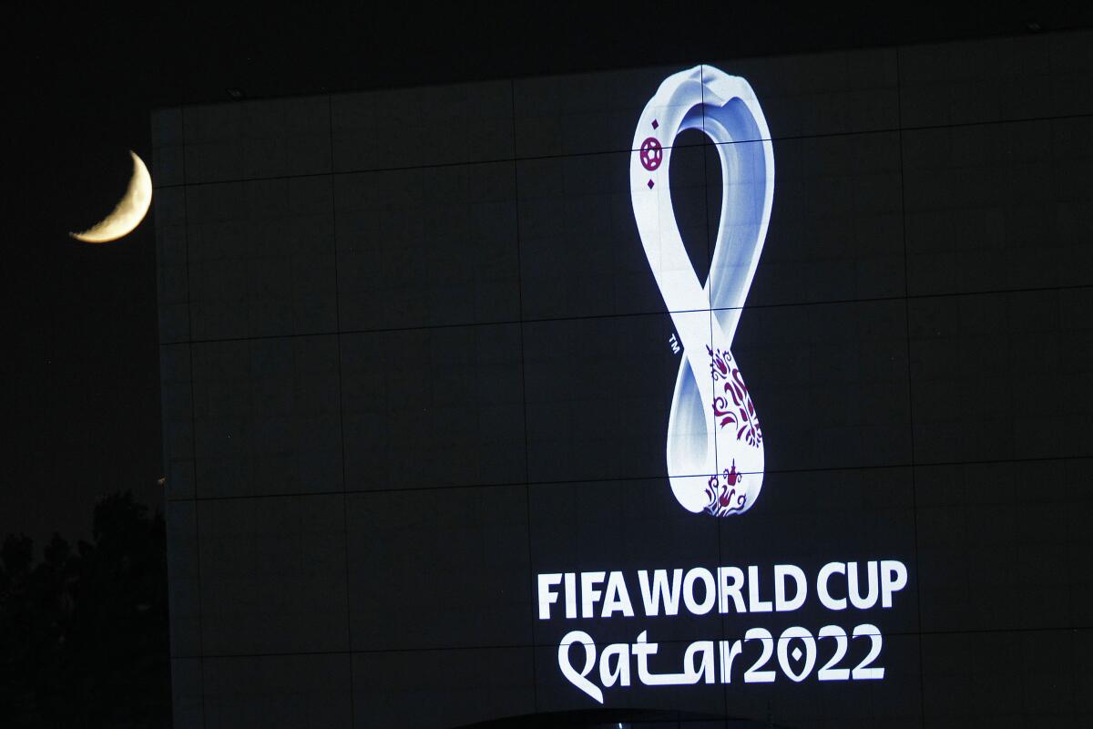 2022 Qatar World Cup logo projected onto a building