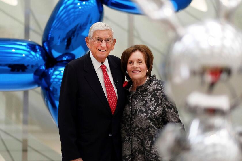 FILE - In this Sept. 16, 2015 file photo, Eli Broad and his wife, Edythe, stand for a photo amid Jeff Koons sculptures at his new museum called "The Broad" in downtown Los Angeles. Eli Broad, a charter school advocate has contributed at least $3.7 million since 2007 to political efforts to expand charter schools. (AP Photo/Richard Vogel,file)
