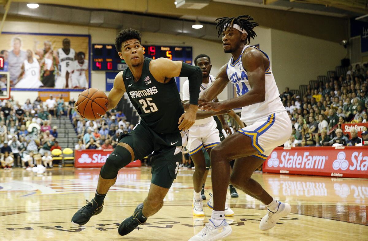 Michigan State forward Malik Hall tries to get around UCLA forward Jalen Hill.