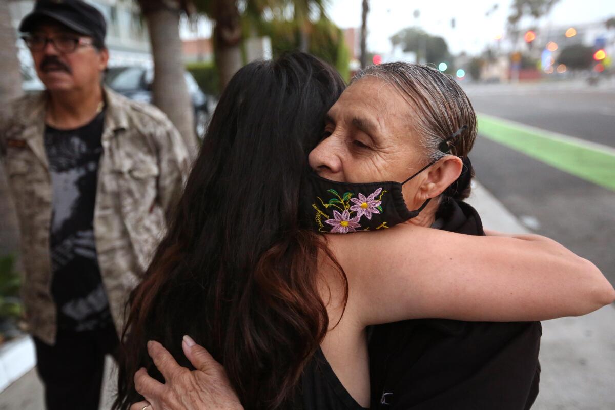 Amparo Rodriguez gets a hug of support from Maria Hernandez.