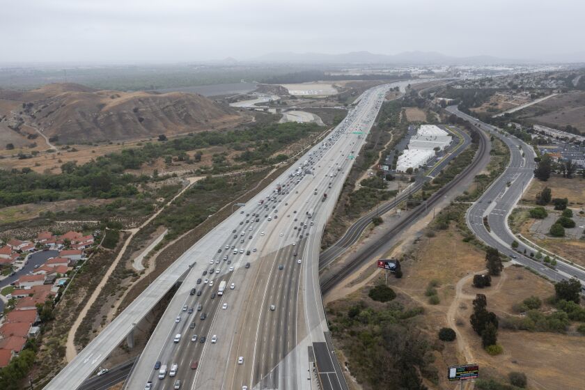 CORONA, CA - May 20: An aerial view of traffic on the 91 Freeway and the Green River Rd. overpass where there have been more than a dozen instances of cars having their windows shot out by bebe guns. Photo taken Thursday, May 20, 2021 in Corona, CA. At least four vehicles were shot at in Anaheim Thursday morning near the WB 91 Freeway. The windows of three cars were shot out on the 91 Freeway in Corona recently, the latest in a string of dozens of similar incidents, according to the California Highway Patrol. The CHP is now investigating roughly 50 shooting incidents that began in late April and have targeted cars traveling on the freeway in Riverside, Orange and Los Angeles counties. (Allen J. Schaben / Los Angeles Times)