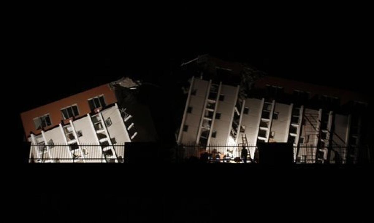 Firemen work on a destroyed building in Concepcion, Sunday, Feb. 28, 2010, after a devastating earthquake struck Chile early Saturday Feb. 27, 2010. (AP Photo/ Natacha Pisarenko)