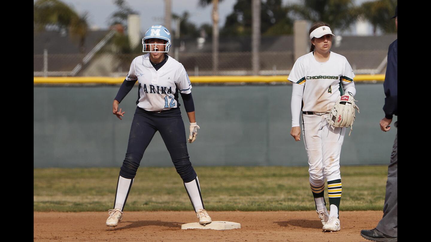 Marina High's Briana Gonzalez, left, reacts after her double drove in two runs during the fourth inning of a Surf League game at Edison on Tuesday.