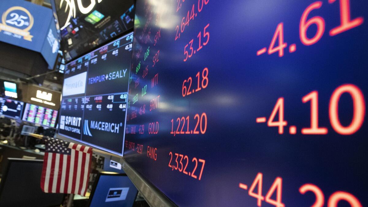 Stock screens are displayed at the New York Stock Exchange, where on Tuesday a broad sell-off effectively wiped out this year’s gains for the major indexes.