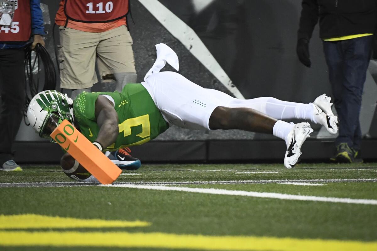 Oregon quarterback Anthony Brown gets the ball into the end zone to score during the third quarter Nov. 13, 2021.