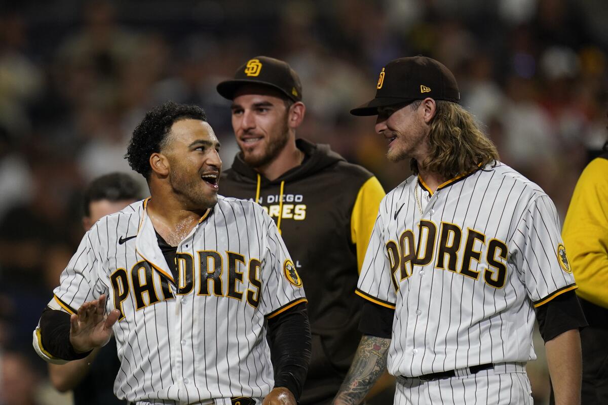 The Padres' Trent Grisham, left, celebrates with teammate Josh Hader 