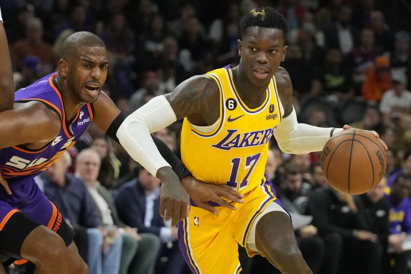 Los Angeles Lakers guard Dennis Schroder (17) drives past Phoenix Suns guard Chris Paul.