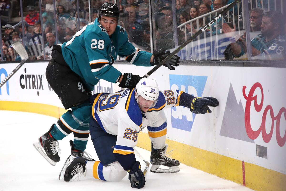 San Jose Sharks' Timo Meier (28) of the looks for the puck against St. Louis Blues' Vince Dunn (29) during the second period in Game 1 of the Western Conference finals during the NHL playoffs.