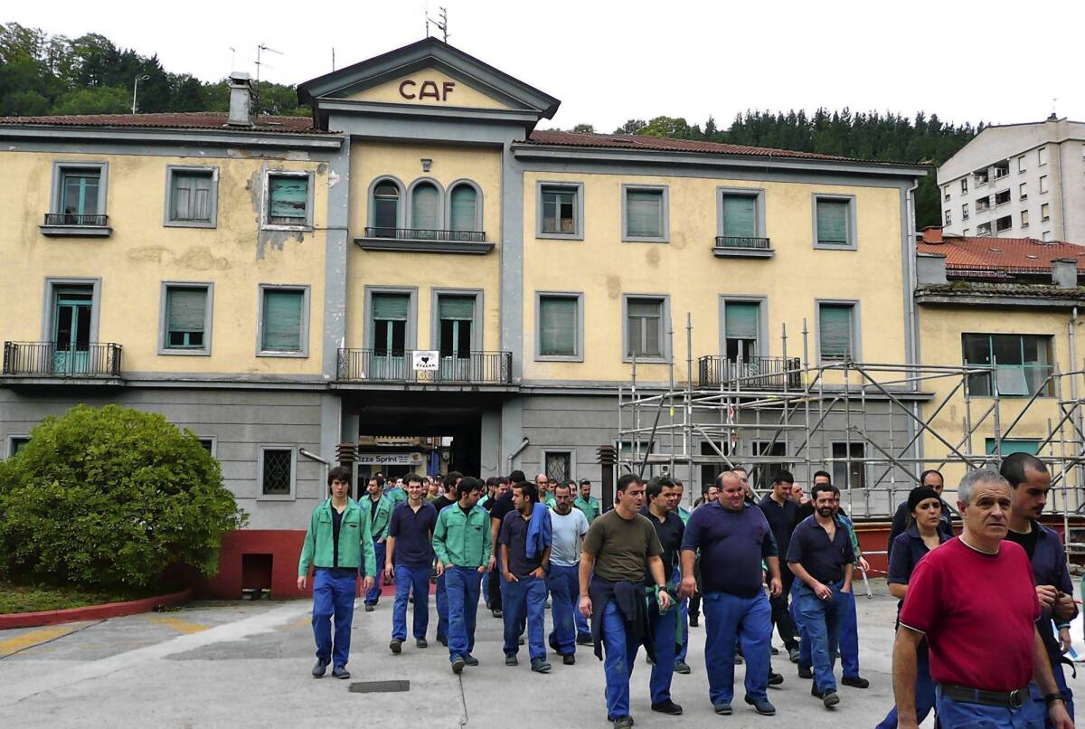 Workers file through the entrance to the CAF headquarters in Beasain, Spain, last month. More than three-quarters of CAF's sales are abroad, unfettered by Spain's economic crisis, and the company has posted operating profits of 10% or more for the last five years.