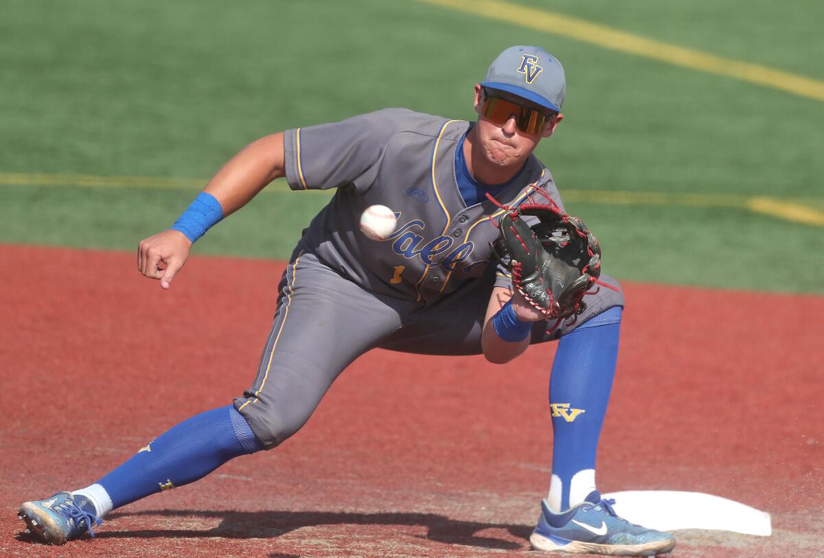 Fountain Valley shortstop Tyler Peshke (1) prepares to tag out a stealing base runner.