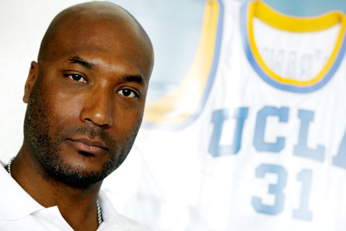 Former UCLA basketball star Ed O'Bannon Jr. sits in his office in Henderson, Nev.