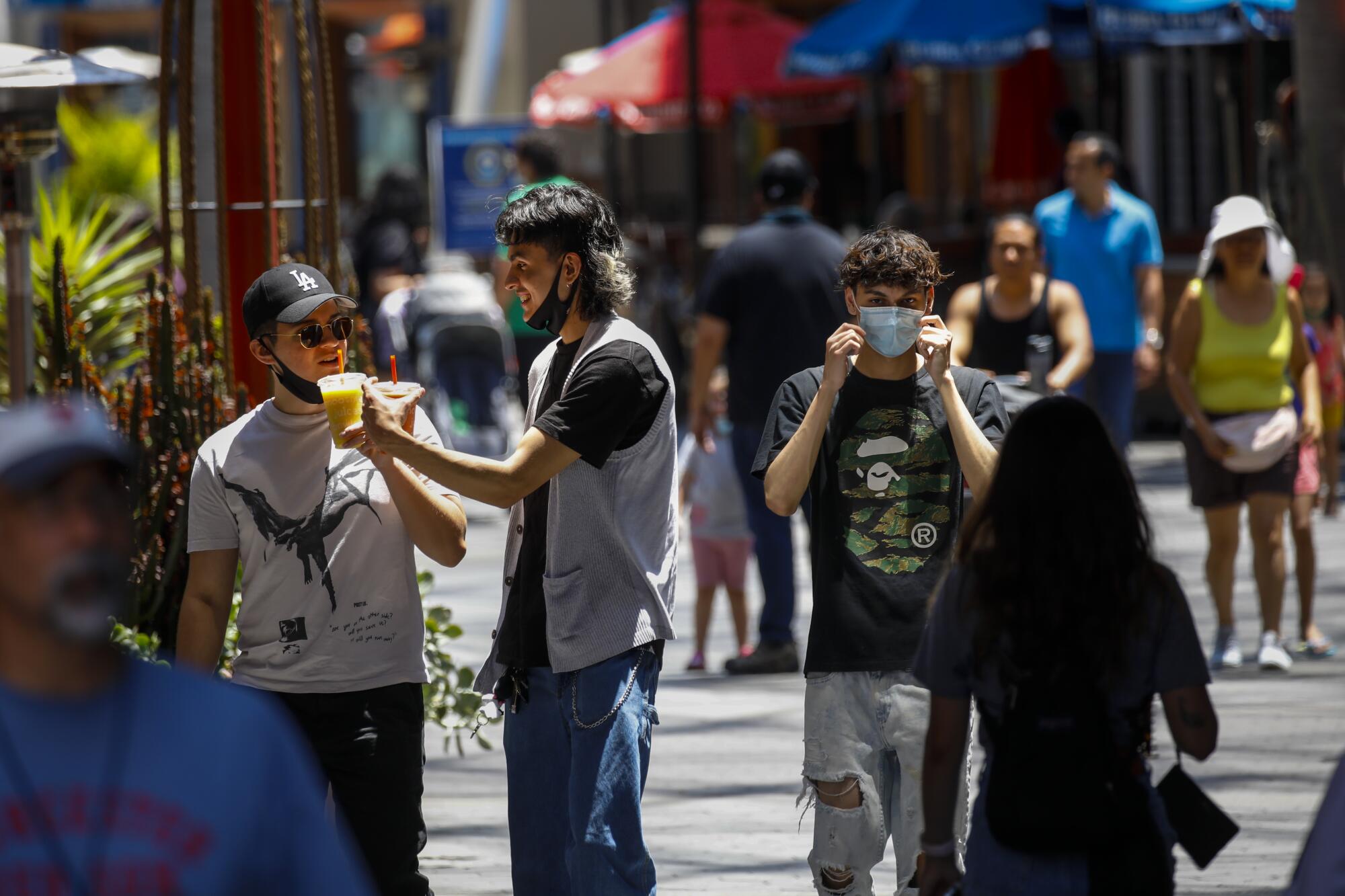 People walk through an outdoor shopping area