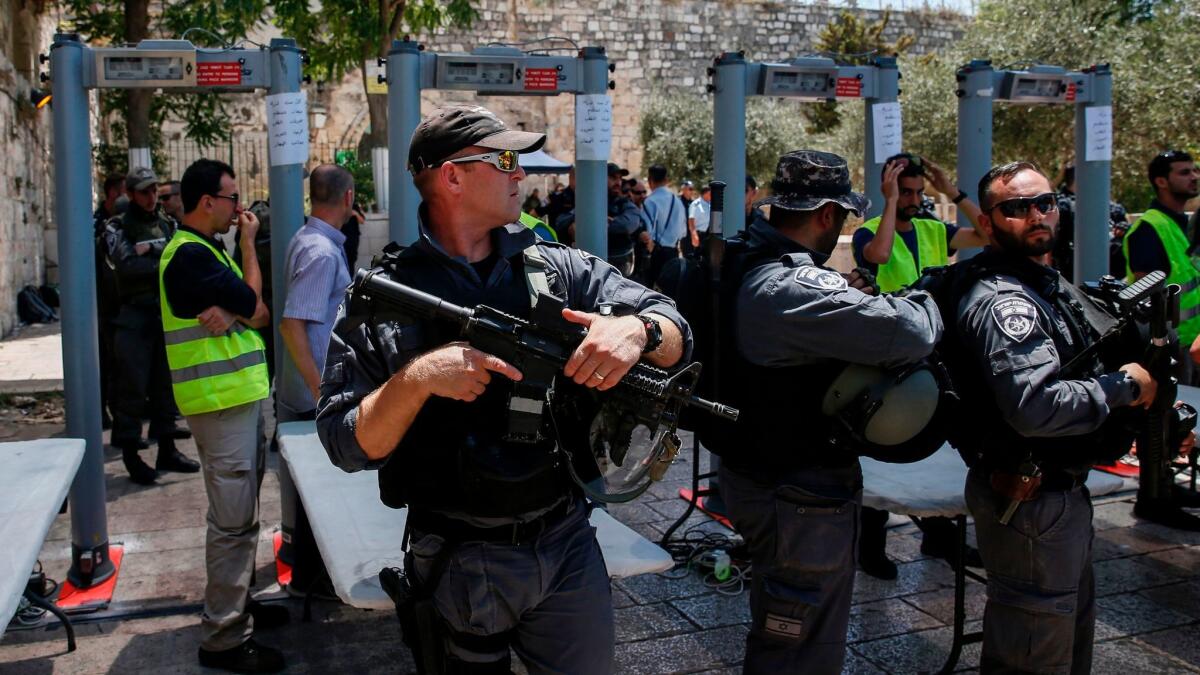 Israeli border police stand guard near newly installed metal detectors at the entrance to Al Aqsa compound in Jerusalem's Old City on July 16, 2017.