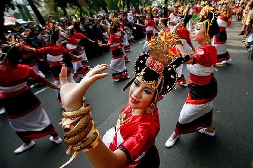 Dancers perform in a parade celebrating the 64th anniversary of Indonesia's independence.