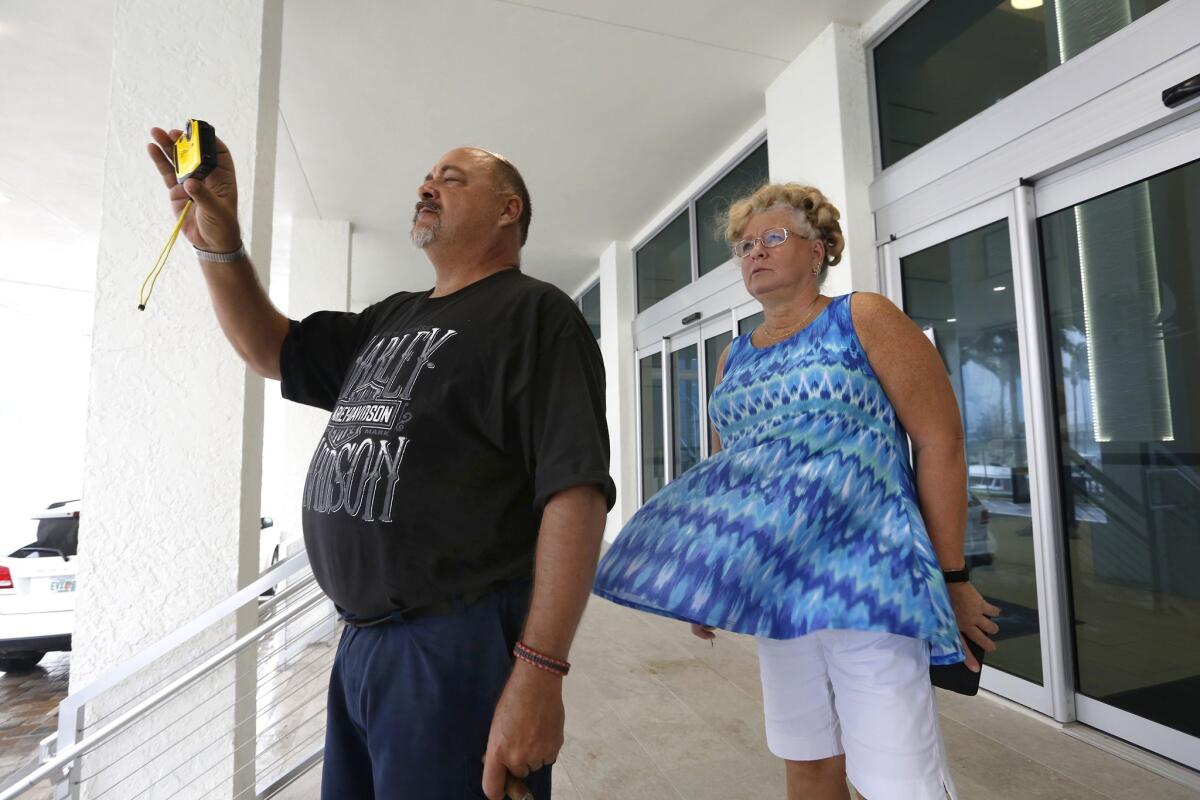 Ken McNeal and Diana Frana of Fort Myers, Fla., watch the hurricane winds at Campo Felice complex.