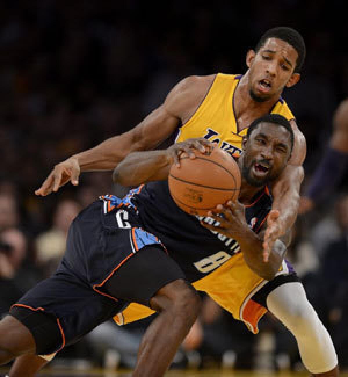 Darius Morris defends against Ben Gordon of the Bobcats.