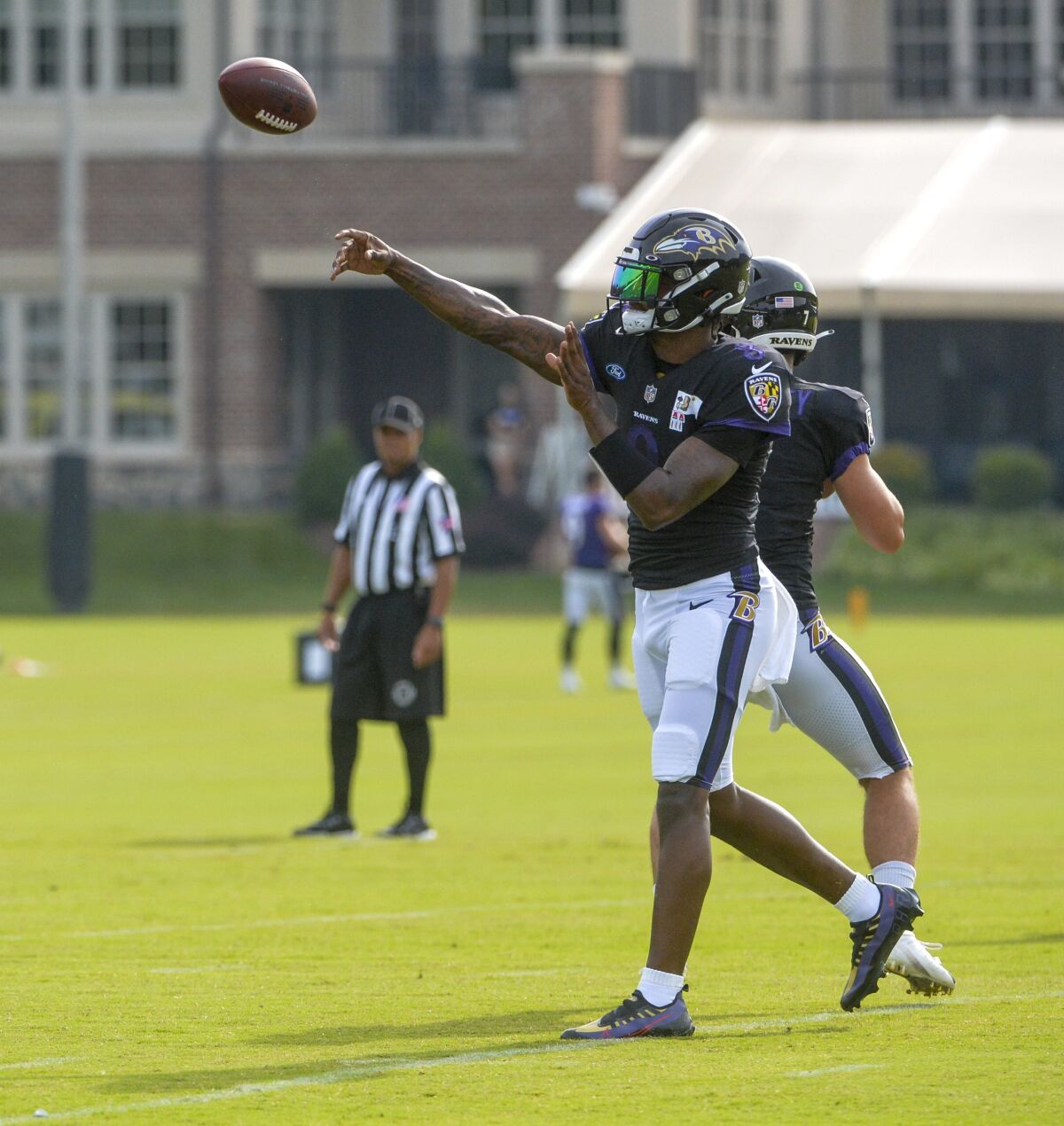 Baltimore Ravens quarterback Lamar Jackson returns to football practice after missing 10-days due to COVID-19. He completes a pass during training camp at Under Armour Performance Center on Aug. 7, 2021 in Owings Mills, Md. (Kevin Richardson/The Baltimore Sun via AP)