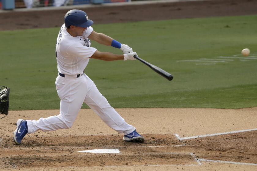 Los Angeles Dodgers' Austin Barnes hits a single to center field against the Seattle Mariners during the first inning of a baseball game in Los Angeles, Tuesday, Aug. 18, 2020. (AP Photo/Alex Gallardo)