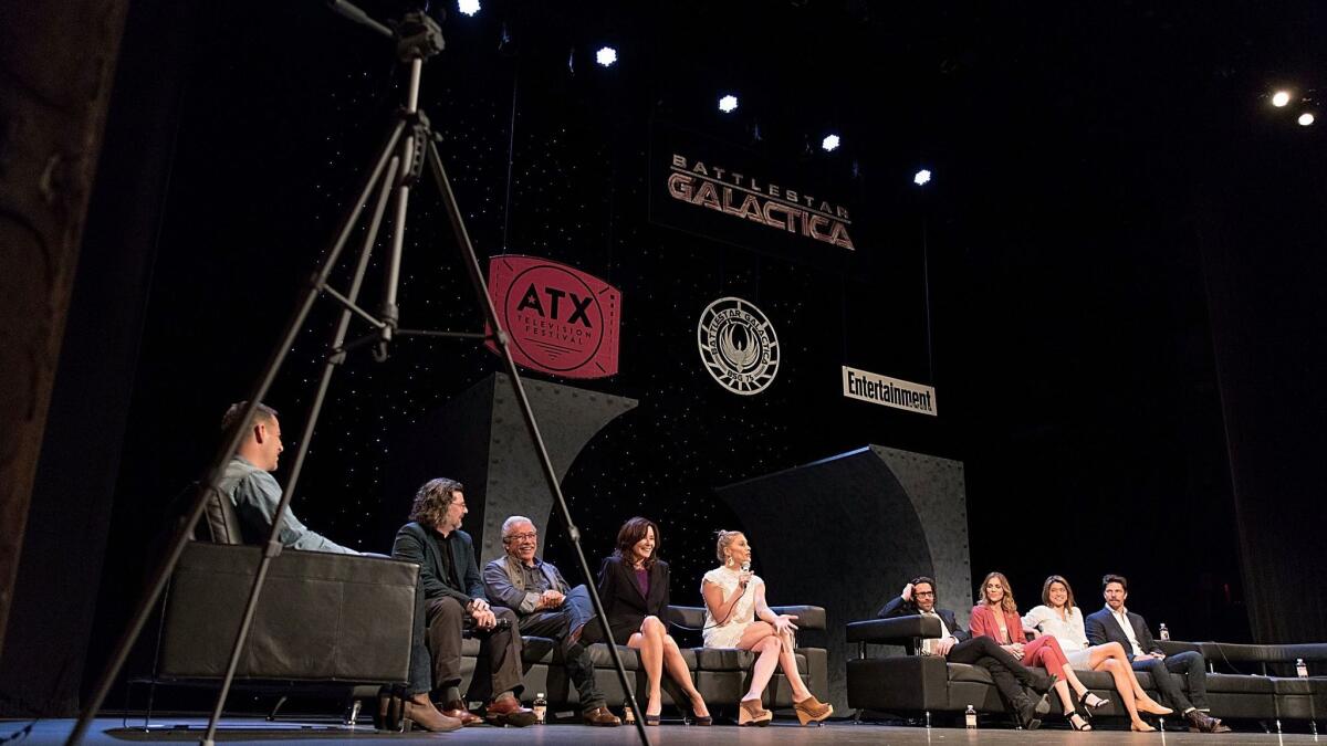 Moderator James Hibberd, from left, Ronald D. Moore, Edward James Olmos, Mary McDonnell, Katee Sackhoff, James Callis, Tricia Helfer, Grace Park and Michael Trucco attend the reunion panel of "Battlestar Galactica" at the ATX Television Festival.