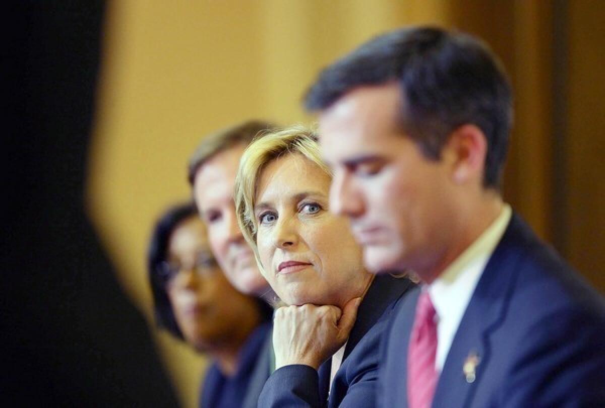 L.A. mayoral hopefuls, from left, Jan Perry, Kevin James, Wendy Greuel and Eric Garcetti listen during a candidates debate in September.