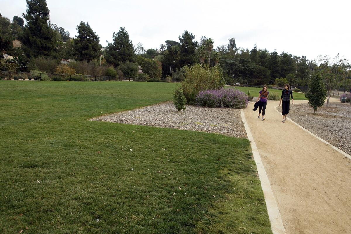 Jane McCarthy, left, and Vanessa Kristal walk along a path by Silver Lake Meadow.
