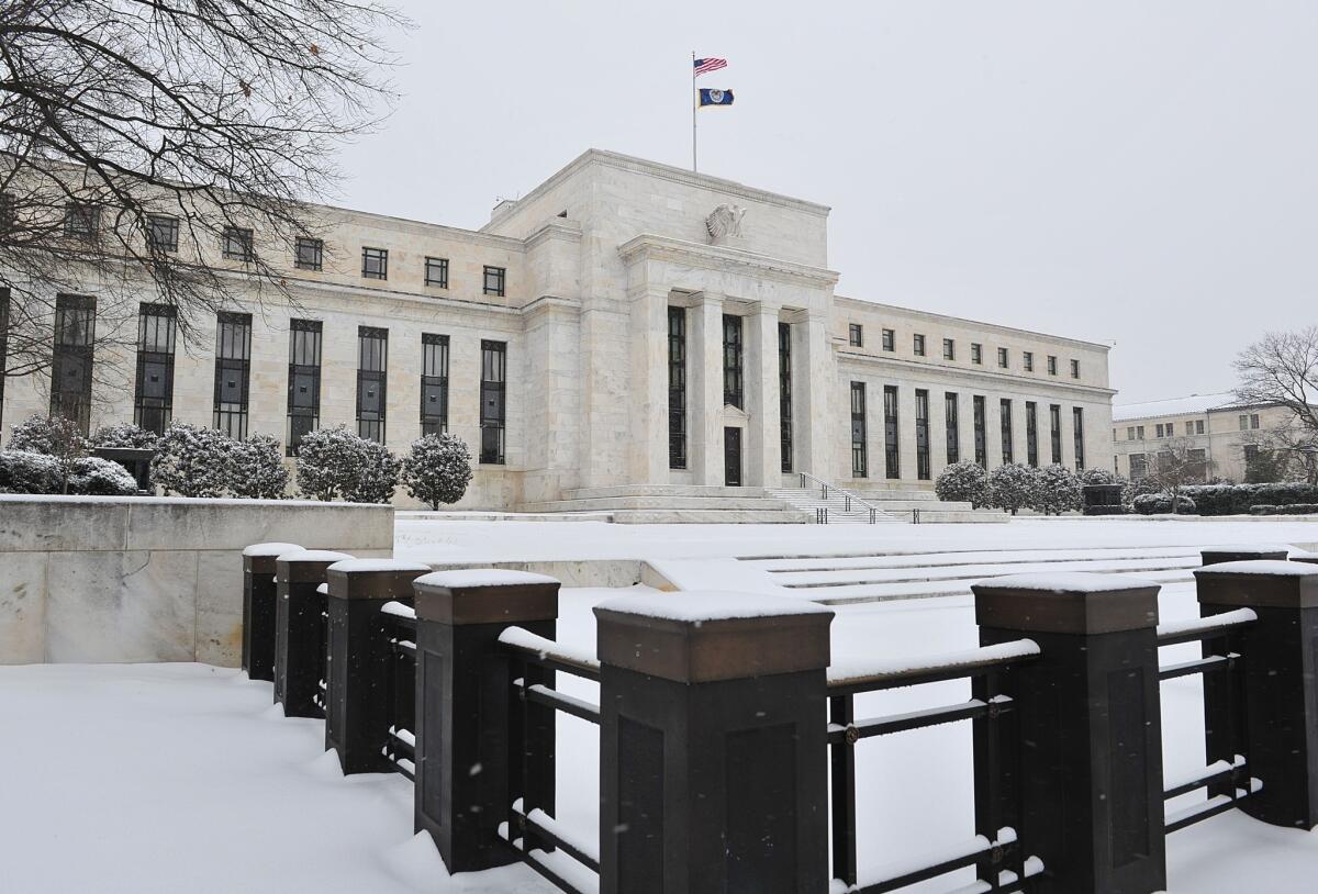 The Federal Reserve building is seen during a snowstorm in Washington.