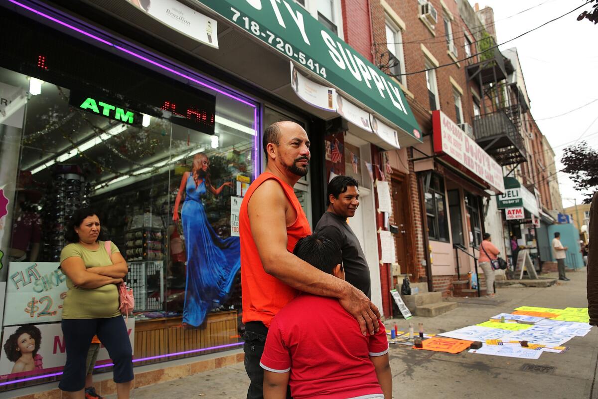 People stand near where Eric Garner died during an encounter with an NYPD officer in July in Staten Island.