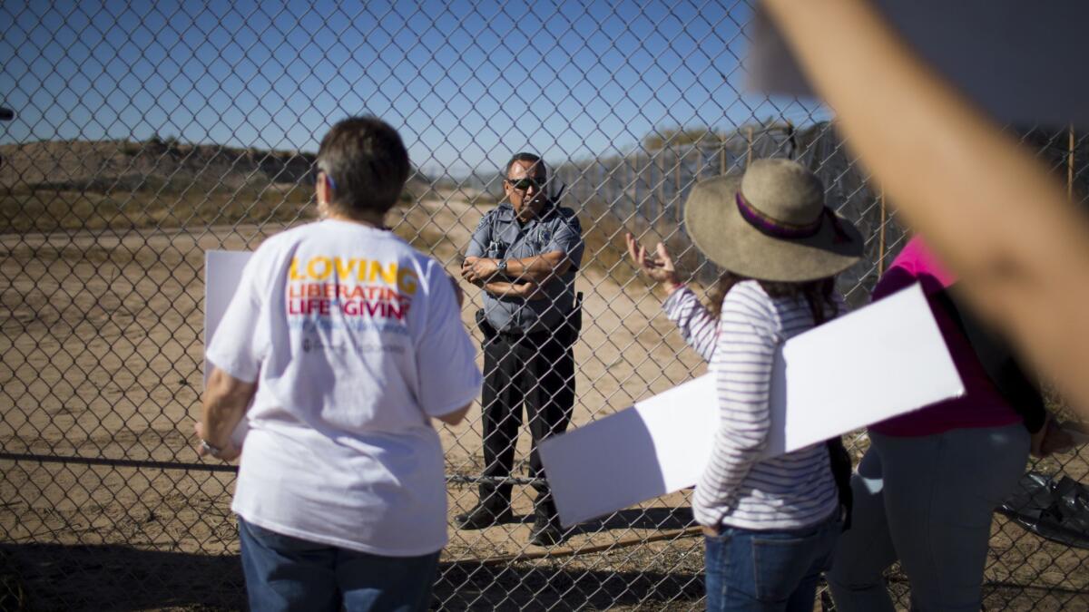 Protestors talk to a guard inside the Tornillo detention camp holding more than 2,300 migrant teens in Tornillo, Texas, on Nov. 15, 2018.