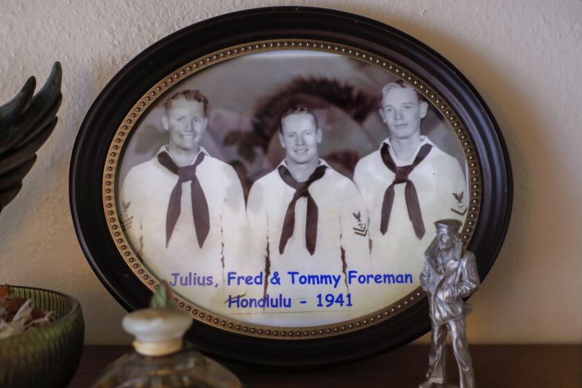 Escondido, CA - December 05: A World War II portrait of Pearl Harbor survivor Tom Foreman, at right, with his brothers Julius and Fred is displayed at the apartment of Tom and his wife Loane at the Cypress Court assisted living facility. (Charlie Neuman / For The San Diego Union-Tribune)