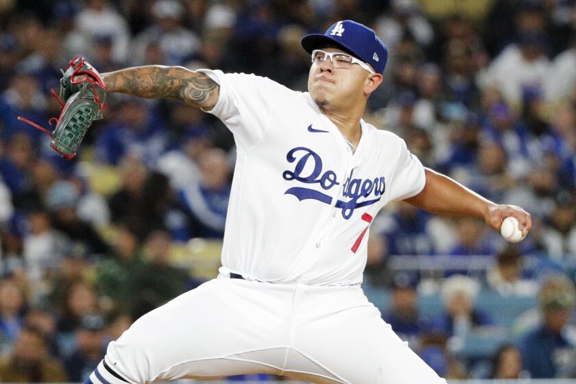 LOS ANGELES, CA - MARCH 30: Los Angeles Dodgers starting pitcher Julio Urias (7) delivers a pitch.